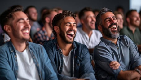 A group of mens between 2050 years, some of them reflexive and other laughing, mid size audience at least 10, majority young, all latin or white, some